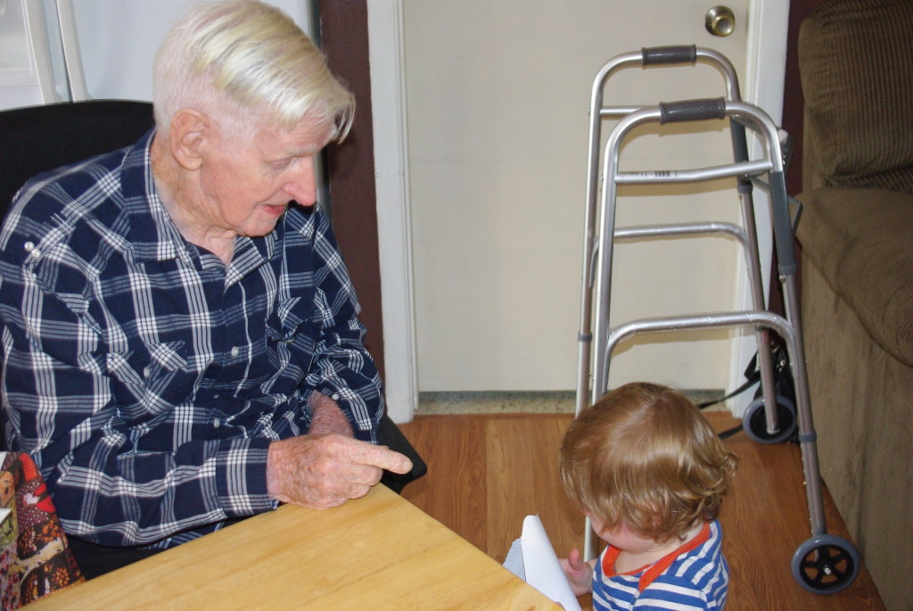 Finn helping Great Grandpa open his birthday card.